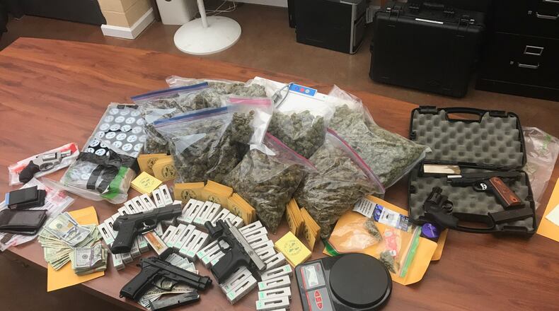 Marijuana, hash oil, and vaping devices pre-loaded with a marijuana substance as well as multiple firearms — some of which had been reported stolen — and more than $3,000 in cash were seized Tuesday from a house in the 5300 block of Sandstone Drive in Fairfield.