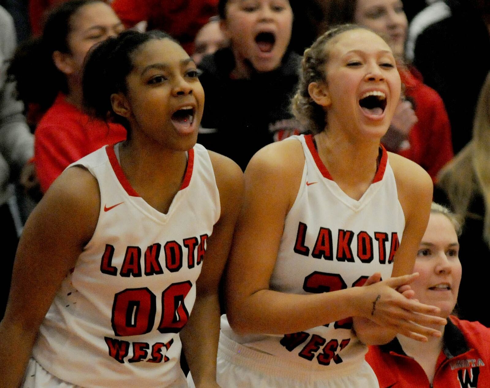 Lakota West’s Jaydis Gales (00) and Angelia Jackson (22) shout encouragement to thier teammates during the closing minutes of the Firebirds’ Division I district final victory over Beavercreek at Princeton on Saturday. CONTRIBUTED PHOTO BY DAVID A. MOODIE