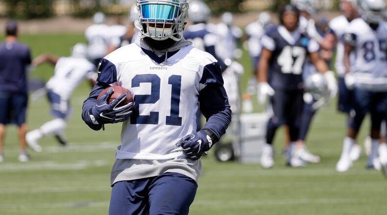 Dallas Cowboys running back Ezekiel Elliott runs the ball during an NFL football practice at the team's training facility, Tuesday, June 13, 2017, in Frisco, Texas. (AP Photo/Tony Gutierrez)