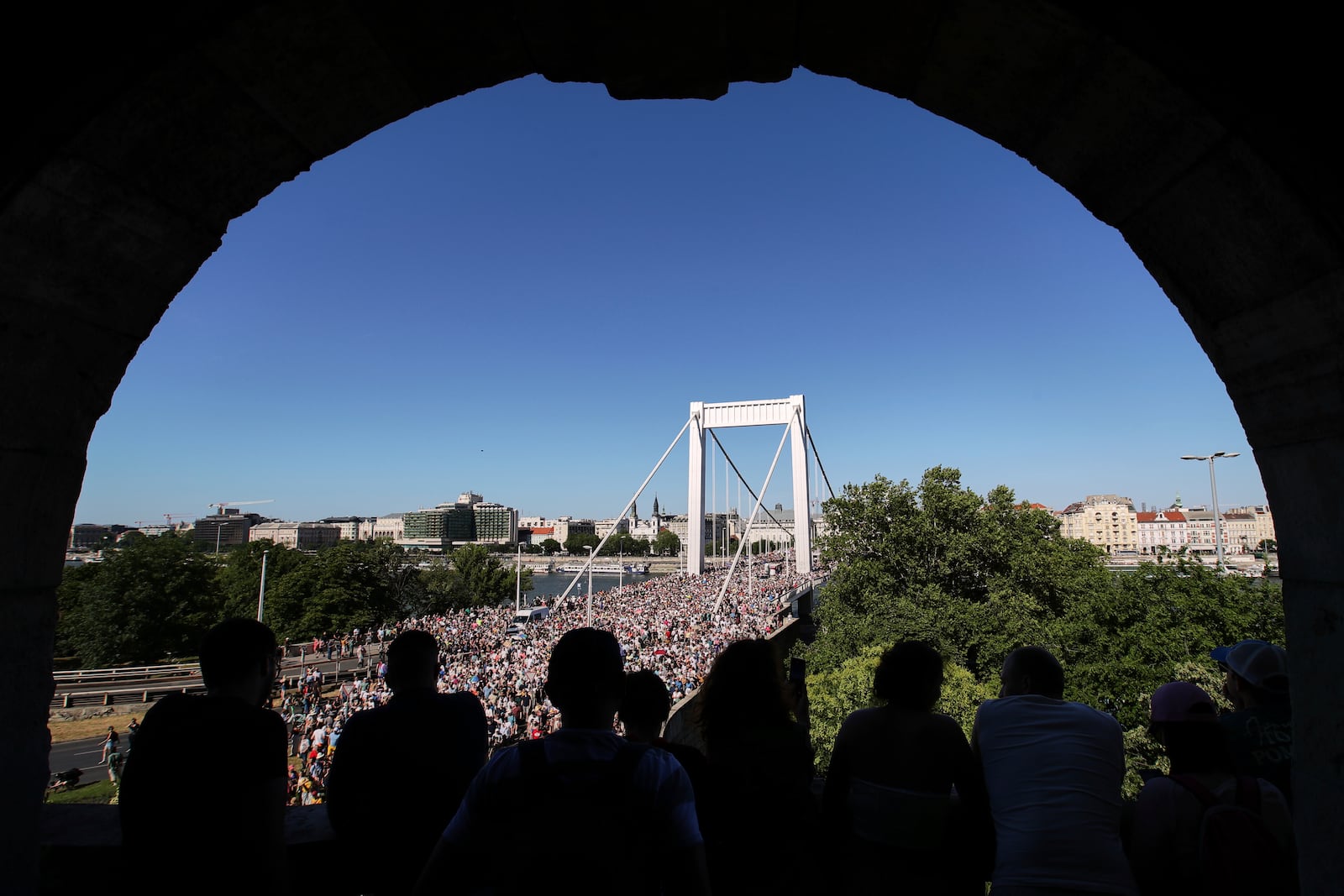 Participants in the Pride march cross the Elisabeth Bridge in Budapest, Hungary, Saturday, June 28, 2025. (AP Photo/Rudolf Karancsi)