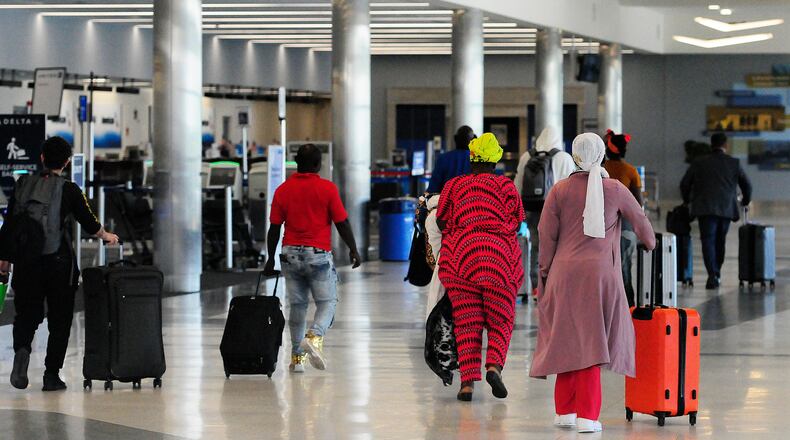 Travelers walk through Dayton International Airport Thursday, June 27, 2024. The airport will be busy for Independence Day week as travel nationwide is expected to be 5% greater than in 2023 and 8% greater than 2019. MARSHALL GORBY/STAFF