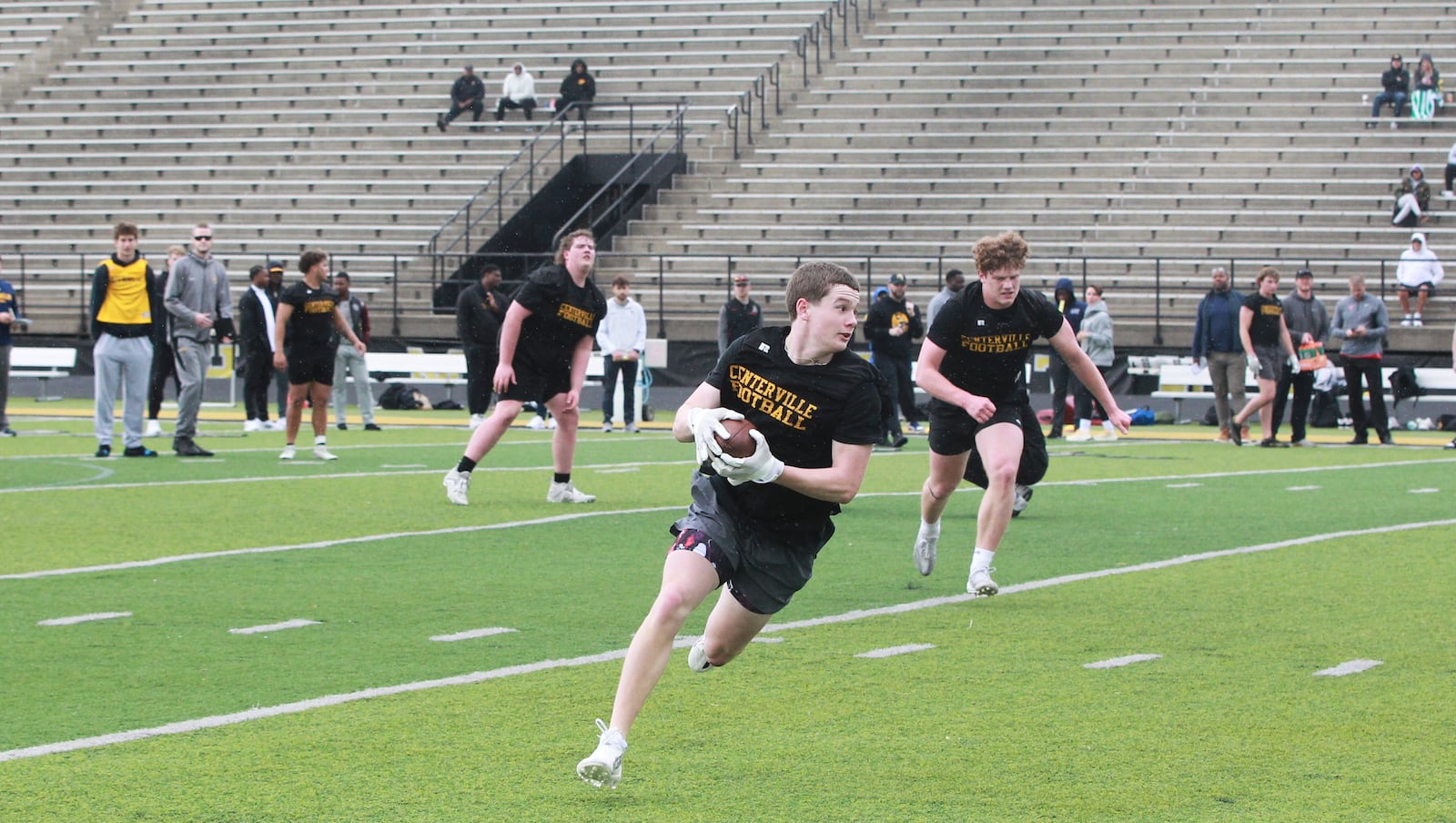 Centerville junior Alex Brink catches a pass and runs with it during the high school football recruiting showcase at CHS on May 6, 2025