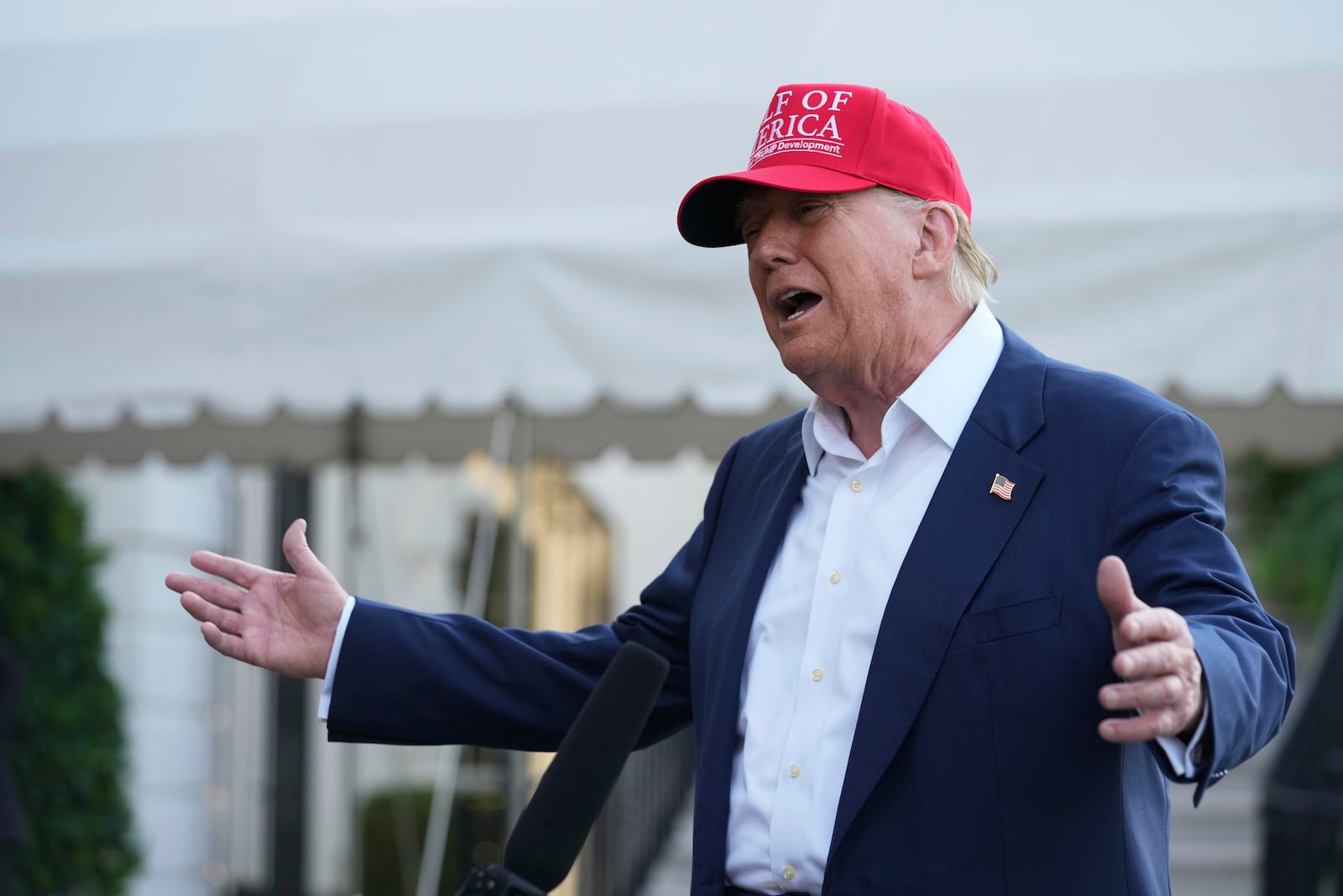 President Donald Trump speaks to the media before walking across the South Lawn of the White House to board Marine One en route to Joint Base Andrews, Md., and on to Florida, Tuesday, July 1, 2025, in Washington. (AP Photo/Mark Schiefelbein)