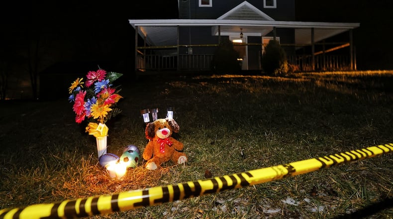 A memorial has been started in front of a house on Greenbush Road in Gratis Twp. where a man and his two children were found dead Monday, Jan. 24, 2022. NICK GRAHAM/STAFF