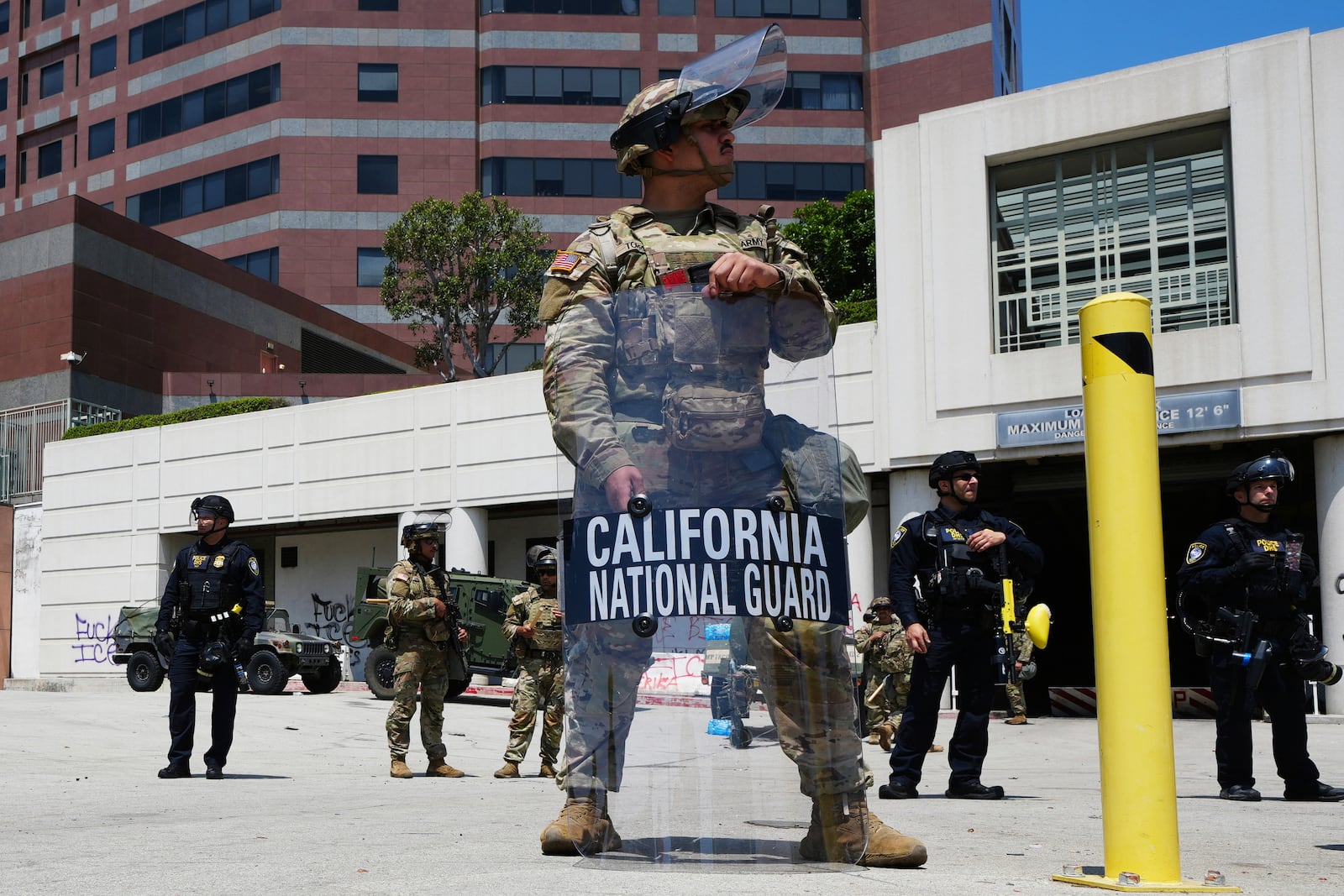 U.S. National Guard stand guard Tuesday, June 10, 2025, in Los Angeles. (AP Photo Damian Dovarganes)