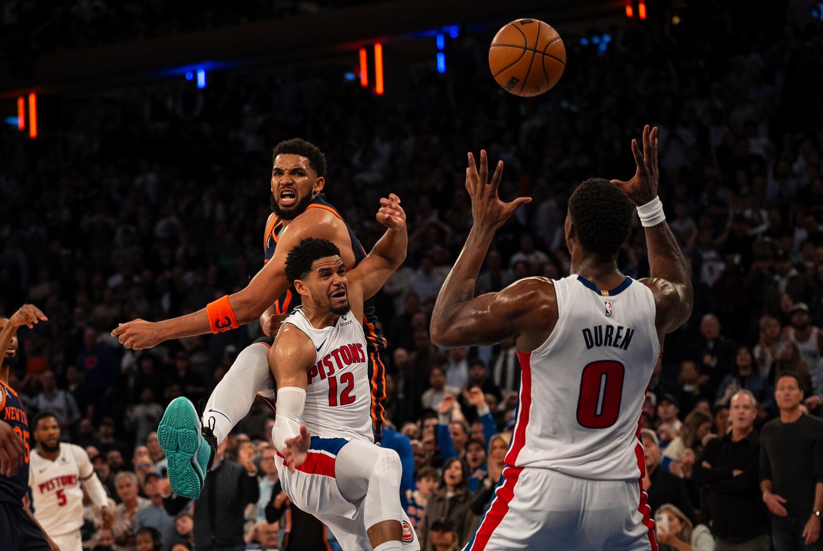 New York Knicks center Karl-Anthony Towns, top left, loses the ball to Detroit Pistons center Jalen Duren (0) at the end of Game 2 of an NBA basketball first-round playoff series, Monday, April 21, 2025, in New York. (AP Photo/Angelina Katsanis)