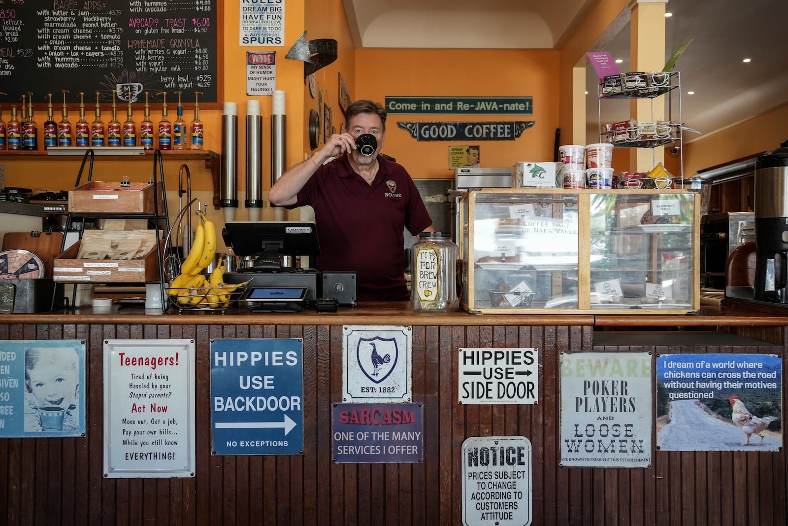 Calistoga Roastery owner Clive Richardson sips coffee behind the counter Tuesday, May 27, 2025, in Calistoga, Calif. (AP Photo/Annika Hammerschlag)