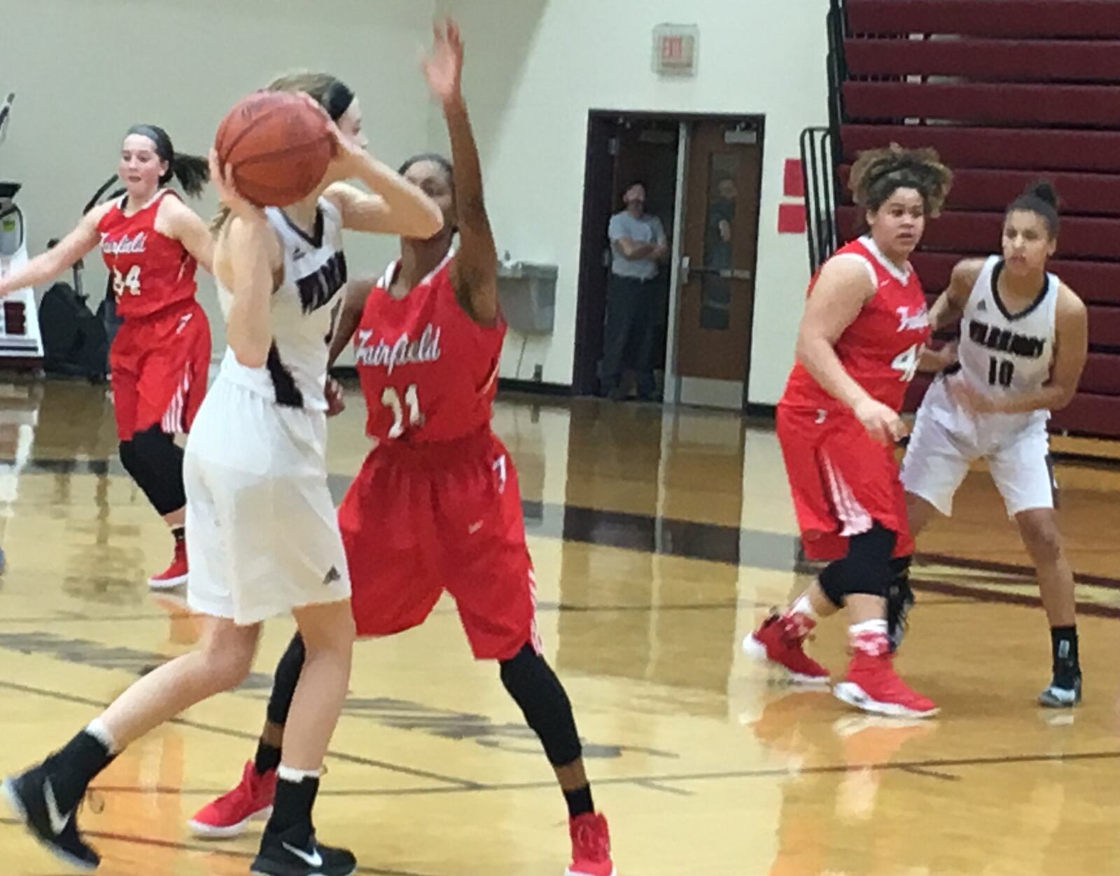 Lebanon’s Sid Rigsby (14) looks for teammate Eva White (10) down low as Fairfield’s Shaniyah Reese (11) and Maddie Schaeffer (42) defend Monday night at Lebanon. RICK CASSANO/STAFF