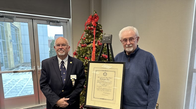 Stu Locke (left), president of the Middletown Rotary Club, presents the 100-year-old charter to Sam Ashworth of the Middletown Historical Society on Dec.16, 2025. CONTRIBUTED