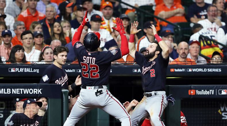 HOUSTON, TEXAS - OCTOBER 29: Juan Soto #22 of the Washington Nationals is congratulated by his teammate Adam Eaton #2 after hitting a solo home run against the Houston Astros during the fifth inning in Game Six of the 2019 World Series at Minute Maid Park on October 29, 2019 in Houston, Texas. (Photo by Elsa/Getty Images)