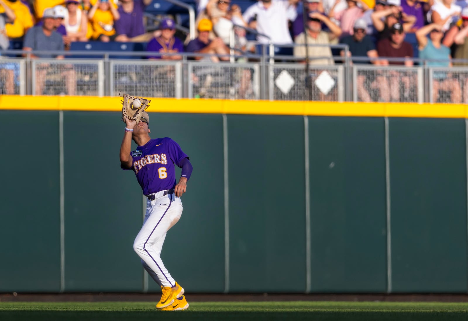 LSU's Derek Curiel (6) catches a fly ball hit by Coastal Carolina's Walker Mitchell in the sixth inning of Game 1 of the NCAA College World Series baseball finals in Omaha, Neb., Saturday, June 21, 2025. (AP Photo/Rebecca S. Gratz)