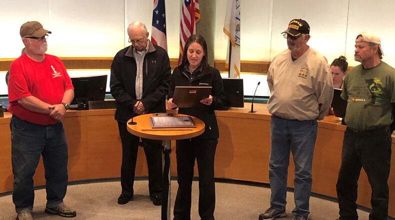 Middletown Mayor Nicole Condrey reads a proclamation during last week's City Council meeting declaring March Vietnam Veterans Day in the city. From left, Mike Gomia, Harvey Poff, Condrey, Paul Hannah and Randy Cornett. RICK McCRABB/STAFF