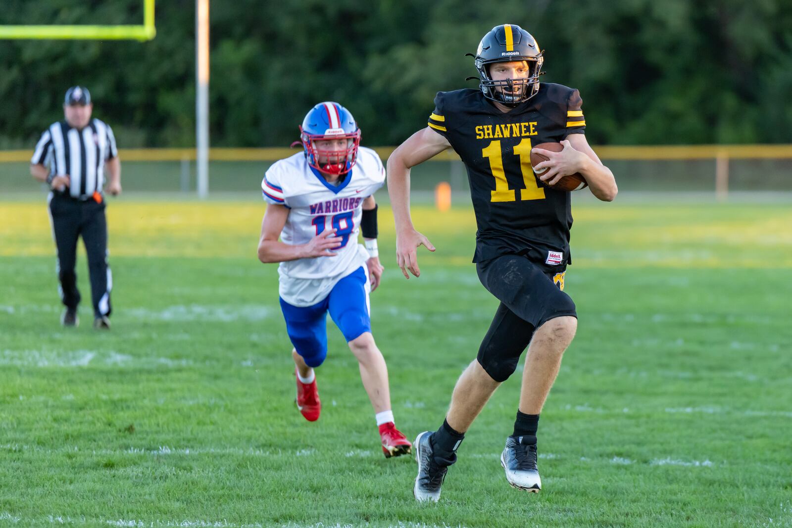 Shawnee High School sophomore quarterback Derek Boehmer runs past a Northwestern during their game on Friday, Sept. 26 in Springfield Twp. The Warriors beat the Braves 28-13. RODNEY GETZ / CONTRIBUTED PHOTO