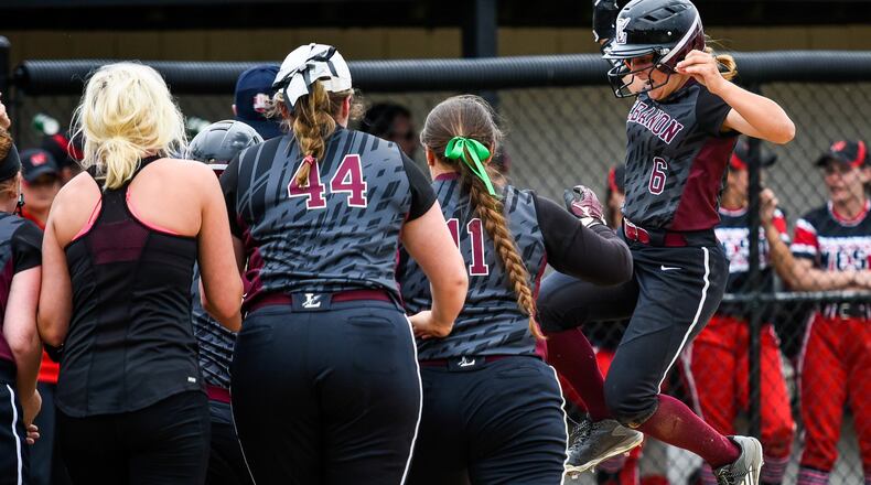 Lebanon’s Chloe Allen jumps onto home plate as teammates cheer her on after hitting a home run during their Division I regional semifinal against Lakota West on May 24 at Centerville. NICK GRAHAM/STAFF