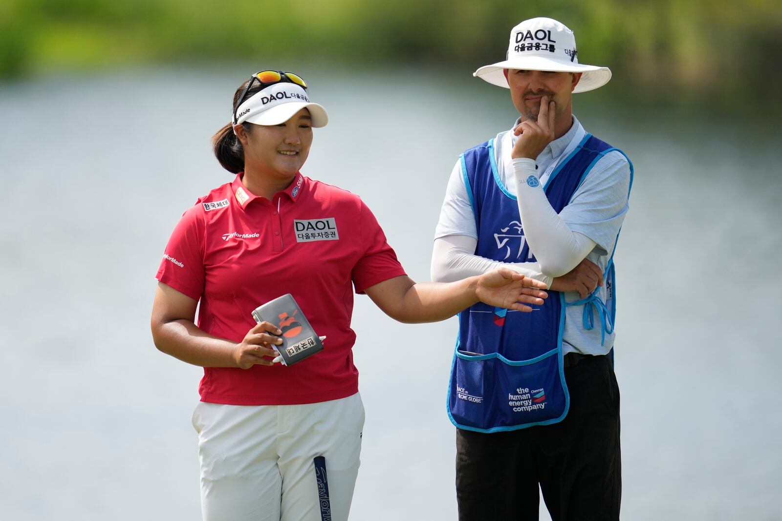 Haeran Ryu, of South Korea, speaks on the 17th green during the third round of the Chevron Championship LPGA golf tournament Saturday, April 26, 2025, in The Woodlands, Texas. (AP Photo/Ashley Landis)