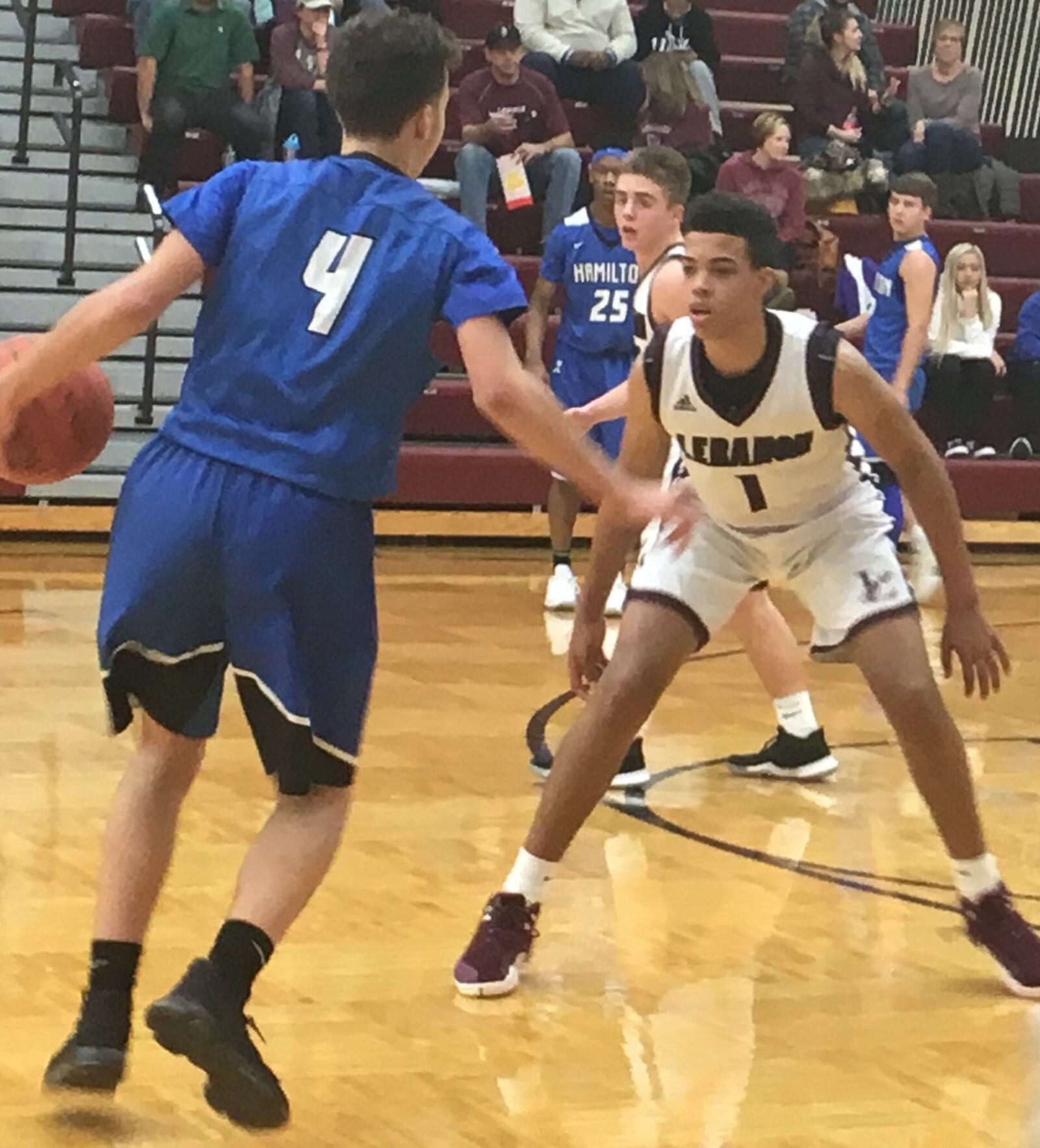 Lebanon’s Harrison Hookfin (1) defends Hamilton’s Jaylen Robinson during Friday night’s game at Lebanon. The host Warriors improved to 9-1 with a 63-55 victory. RICK CASSANO/STAFF