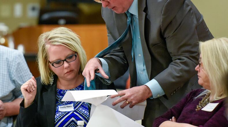 Middletown Division of Police Chief Rodney Muterspaw talks to Brandy Slavens, left, with Access Counseling Services during a Heroin Summit Meeting Monday, March 20 at Atrium Medical Center in Middletown. NICK GRAHAM/STAFF