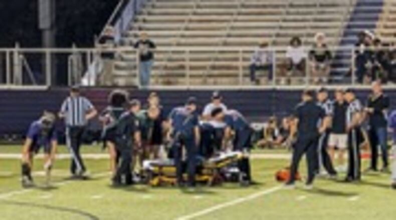 Middletown and Sycamore high school trainers and Middletown EMS members cared for a football official, Tim Hunsaker, who was hit by a player during a Sept. 13 game at Barnitz Stadium. SUBMITTED PHOTO