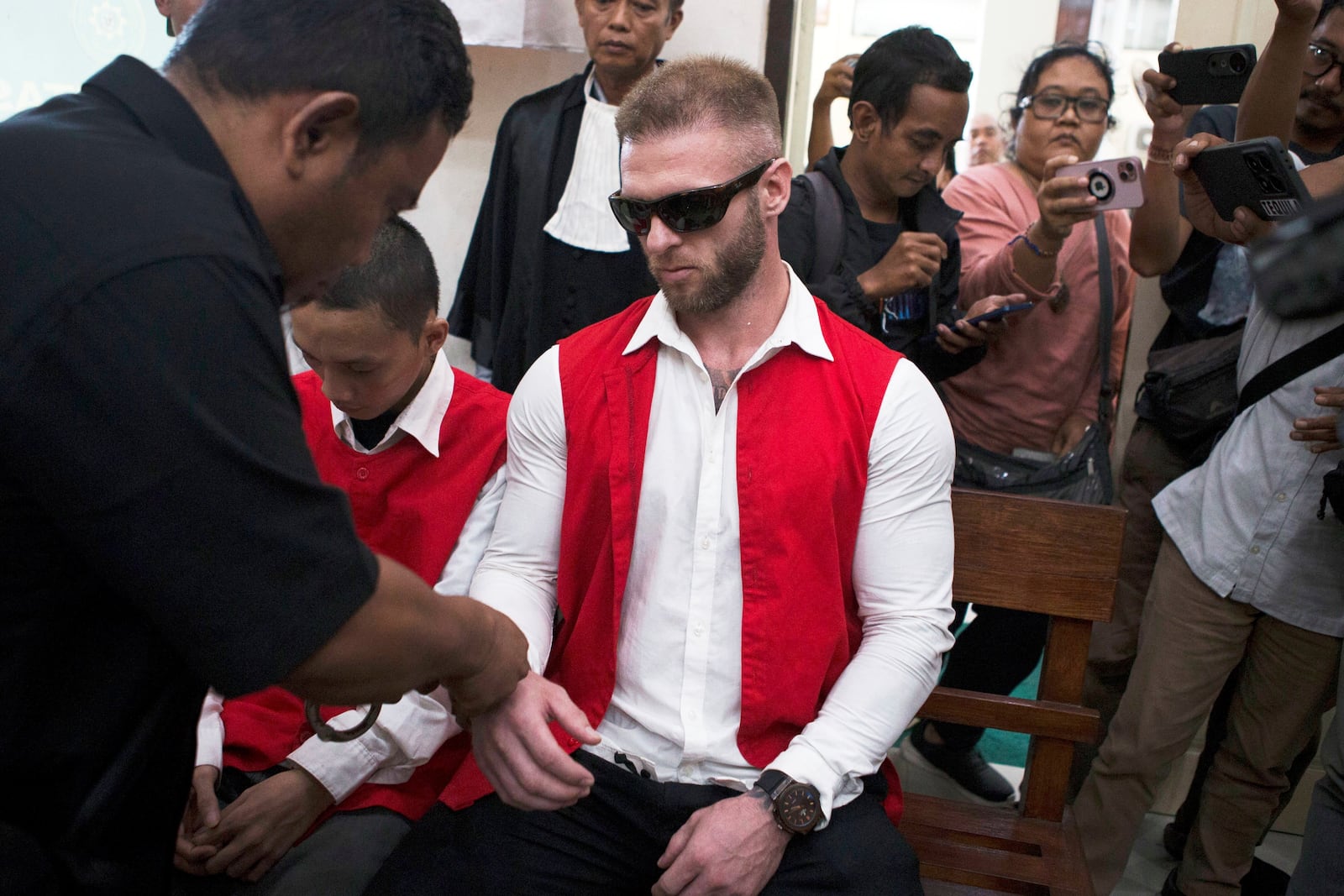 British citizen Thomas Parker who is accused of drug offenses sits on the defendant's chair before the start of his trial hearing at a district court in Denpasar, Bali, Indonesia, Tuesday, May 20, 2025. (AP Photo/Firdia Lisnawati)