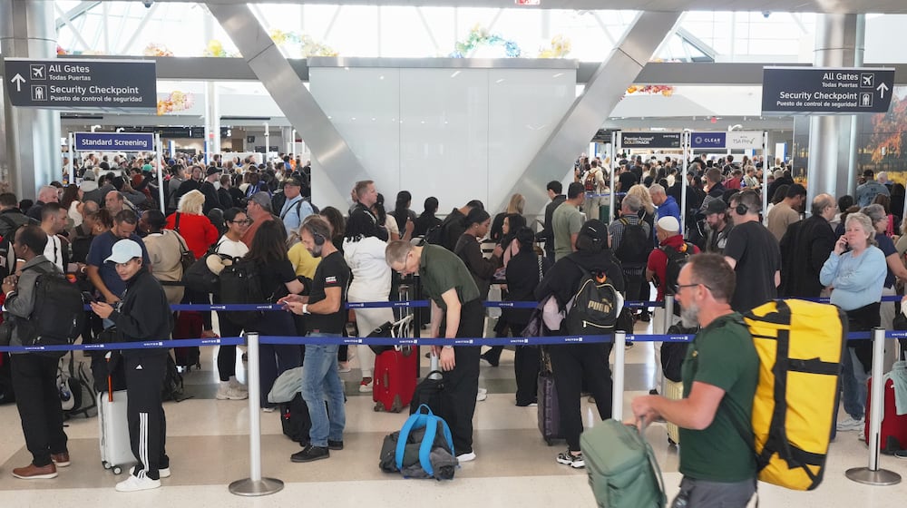 Airline passengers wait in long lines to get through the TSA security screening at George Bush Intercontinental Airport in Houston on Wednesday, March 18, 2026. (AP Photo/Lekan Oyekanmi)