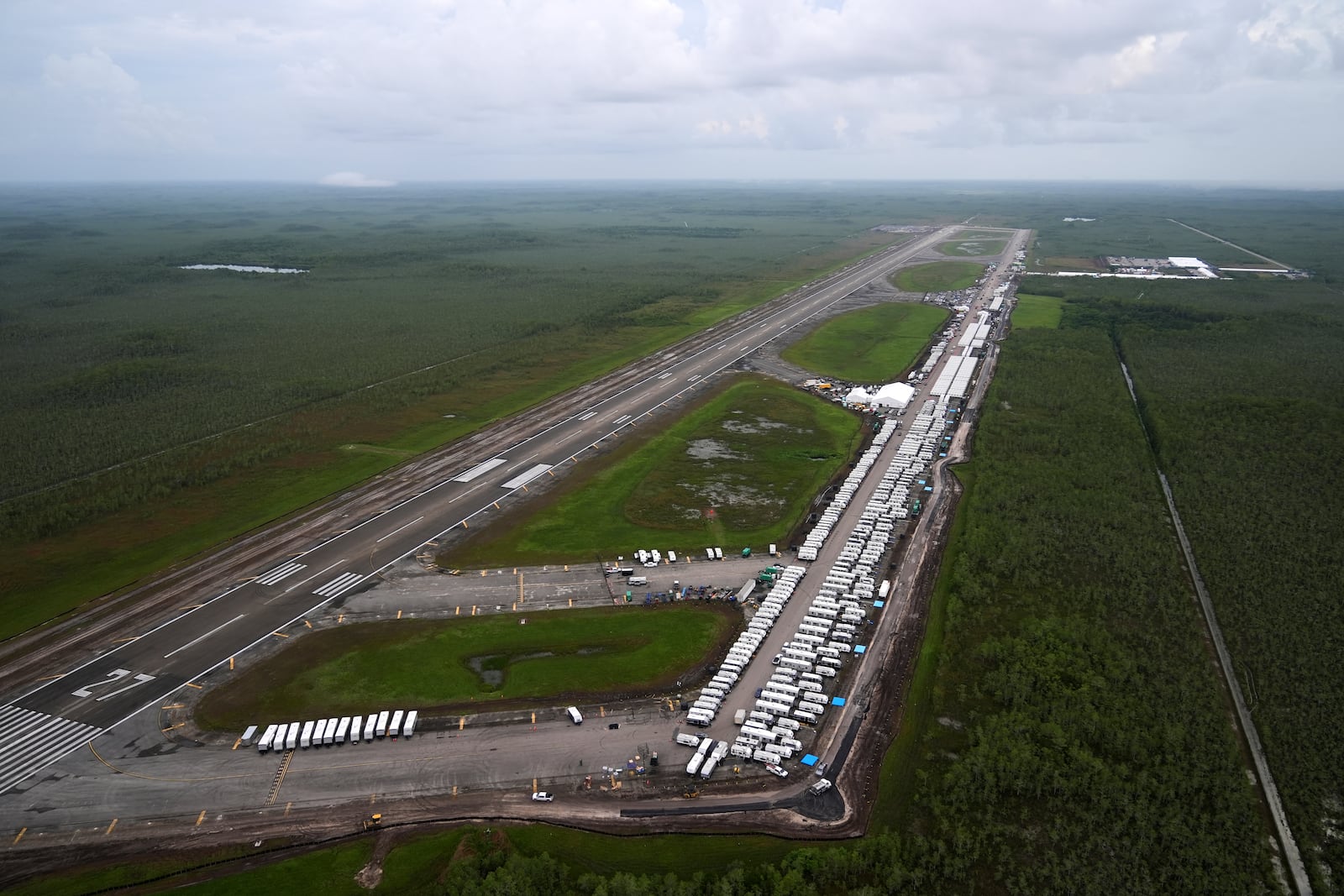Work progresses on a new migrant detention facility dubbed "Alligator Alcatraz," at Dade-Collier Training and Transition facility in the Florida Everglades, Friday, July 4, 2025, in Ochopee, Fla. (AP Photo/Rebecca Blackwell)