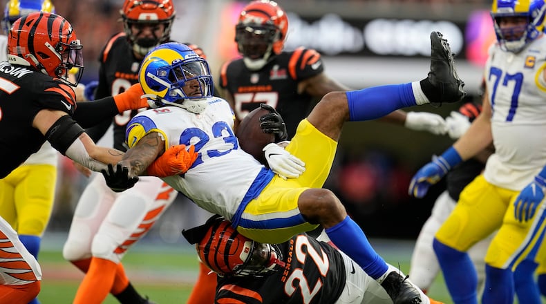 Los Angeles Rams running back Cam Akers (23) is tackled by Cincinnati Bengals cornerback Chidobe Awuzie (22) during the first half of the NFL Super Bowl 56 football game Sunday, Feb. 13, 2022, in Inglewood, Calif. (AP Photo/Marcio Jose Sanchez)