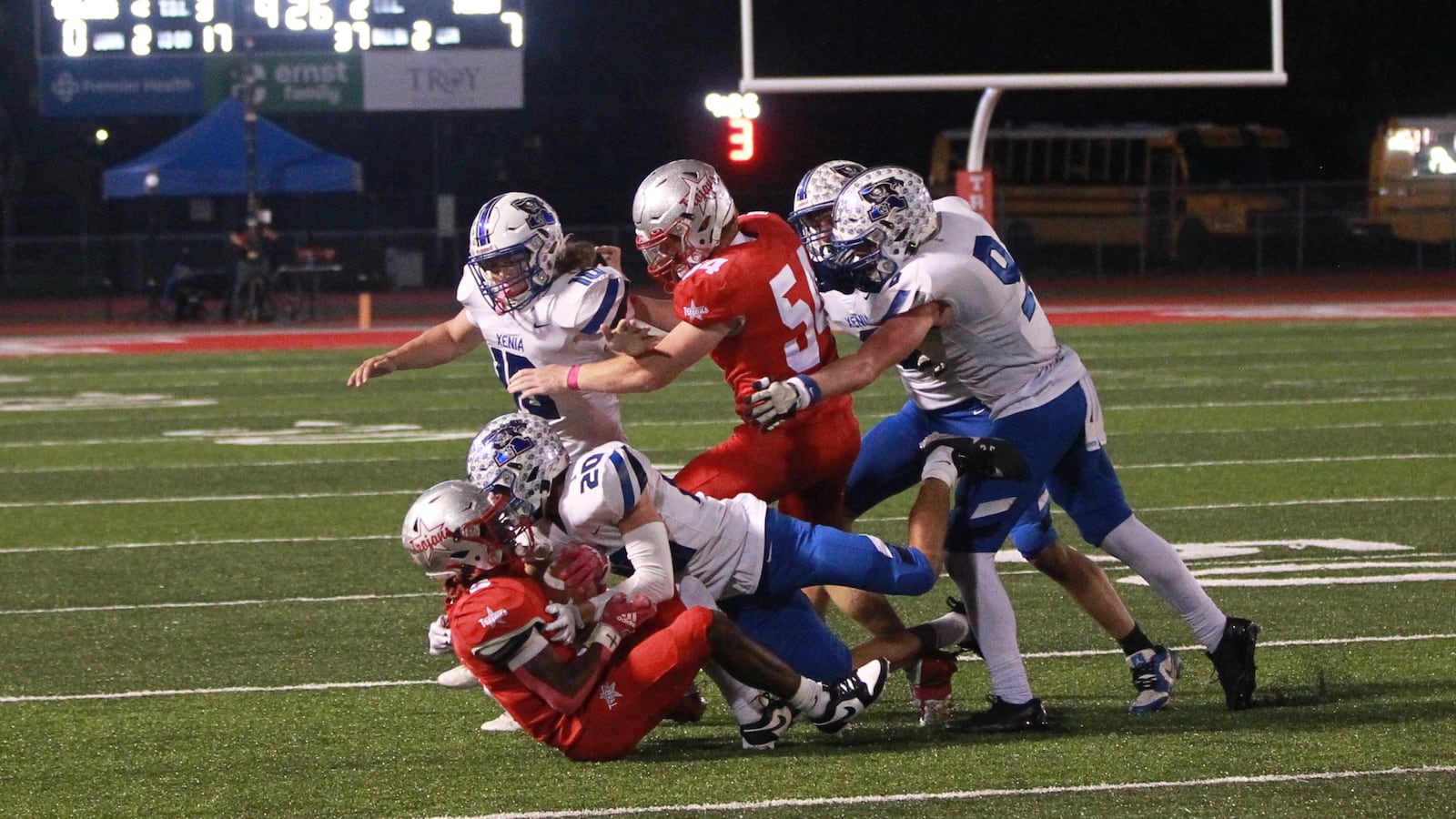 Xenia's Trimonde Henry tackles Kayden Franklin of Troy
