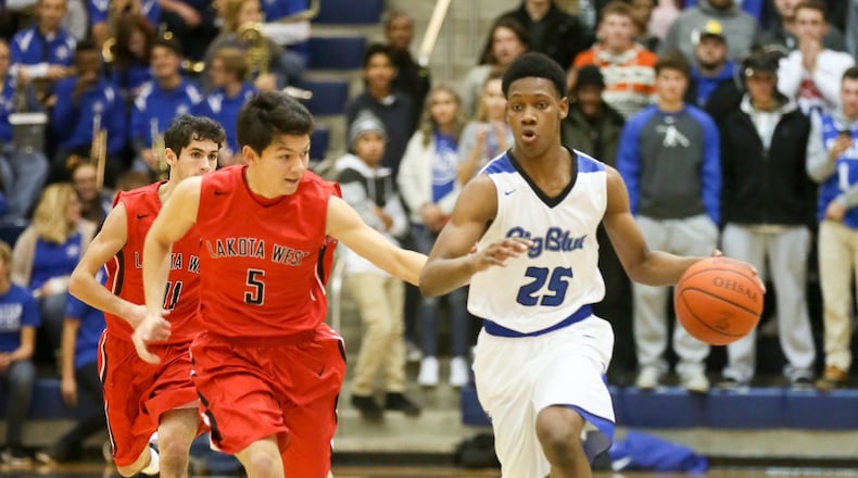 Hamilton guard D’Marco Howard (25) brings the ball up the court against Lakota West’s Will Nguyen during their game at the Hamilton Athletic Center on Dec. 16, 2016. GREG LYNCH/STAFF