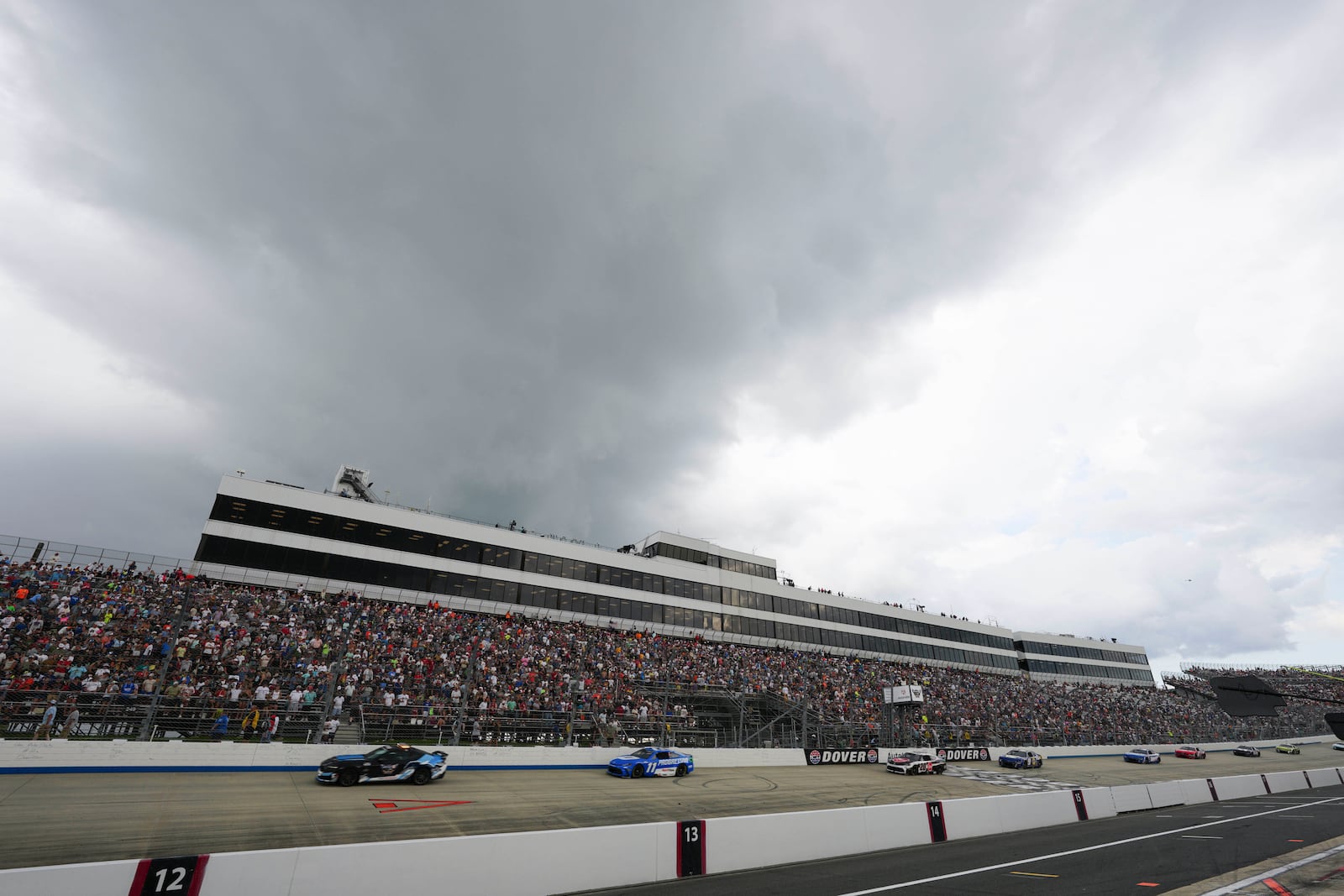 Denny Hamlin (11) drives behind the pace car during a yellow flag for rain during a NASCAR Cup Series auto race at Dover Motor Speedway, Sunday, July 20, 2025, in Dover, Del. (AP Photo/Derik Hamilton)
