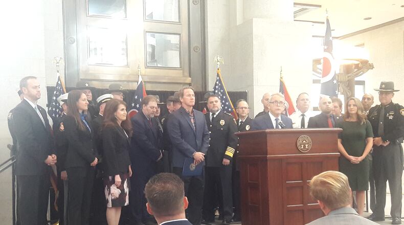 Gov. Mike DeWine and other state officials, backed by members of law enforcement, announce his support for a bill that would direct $250 million in federal funding to grant programs for first responders.