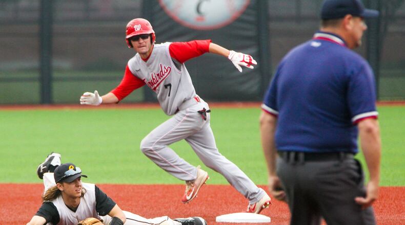 Lakota West’s Bryce Johnson (7) heads for third after a wild throw to Centerville infielder Jared Lieberman (13) during their Division I regional semifinal Thursday at the University of Cincinnati’s Marge Schott Stadium. GREG LYNCH/STAFF
