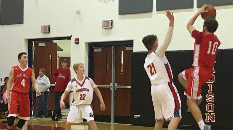Miami Valley’s Alec Martin (10) shoots over Talawanda’s Matthew Bowling (21) on Dec. 28, 2017, at Madison during the Brian Cook Classic. Getting position under the basket are Talawanda’s Craig James (22) and Miami Valley’s Jake Wang (4). THS won 51-48. RICK CASSANO/STAFF