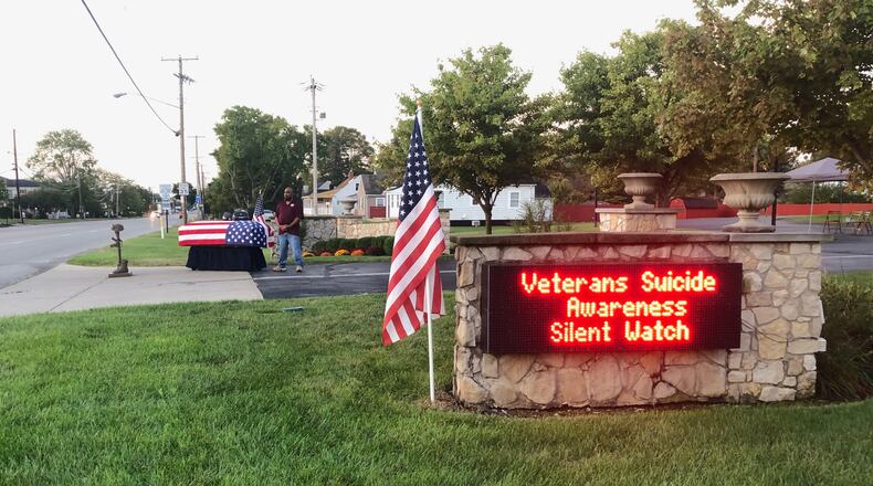 A volunteer stands in silence with a flag draped casket as part of last year's Veterans Suicide Awareness Watch in the driveway of Jackson, Lytle & Lewis Life Celebration Center in Springfield. CONTRIBUTED
