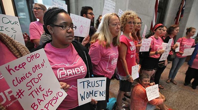 Abortion-rights activists gather inside the Statehouse atrium in June to protest a budget provision that required Ohio abortion clinics to have what are known as patient-transfer agreements with private hospitals no more than 30 miles away. Gov. John Kasich signed into law the budget containing the requirement. CHRIS RUSSELL | THE COLUMBUS DISPATCH