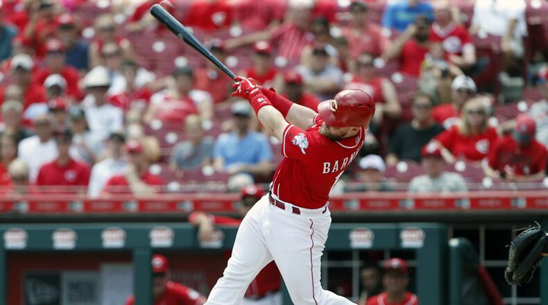 Cincinnati Reds’ Tucker Barnhart hits a two-run home run off St. Louis Cardinals relief pitcher John Gant during the sixth inning of a baseball game, Wednesday, July 25, 2018, in Cincinnati. (AP Photo/Gary Landers)