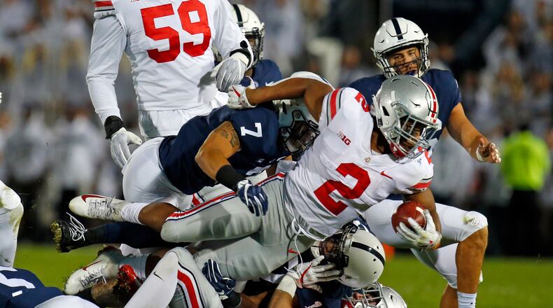 STATE COLLEGE, PA - SEPTEMBER 29: J.K. Dobbins #2 of the Ohio State Buckeyes is tackled by Koa Farmer #7 of the Penn State Nittany Lions on September 29, 2018 at Beaver Stadium in State College, Pennsylvania. (Photo by Justin K. Aller/Getty Images)