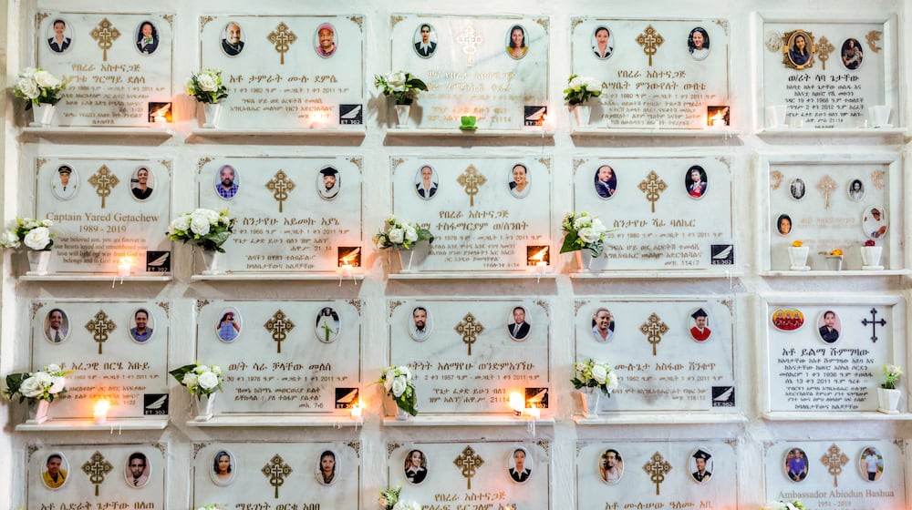 FILE - Candles are lit on a memorial wall during an anniversary service at the Holy Trinity Cathedral in Addis Ababa, Ethiopia, March 8, 2020, to remember those who died in the Ethiopian Airlines flight ET302 crash. (AP Photo/Mulugeta Ayene, File)