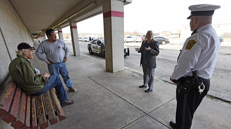 In this file photo, Kathy Becker, a Butler County homeless advocate, and a Hamilton police officer check on homeless residents in the city. STAFF FILE/2015