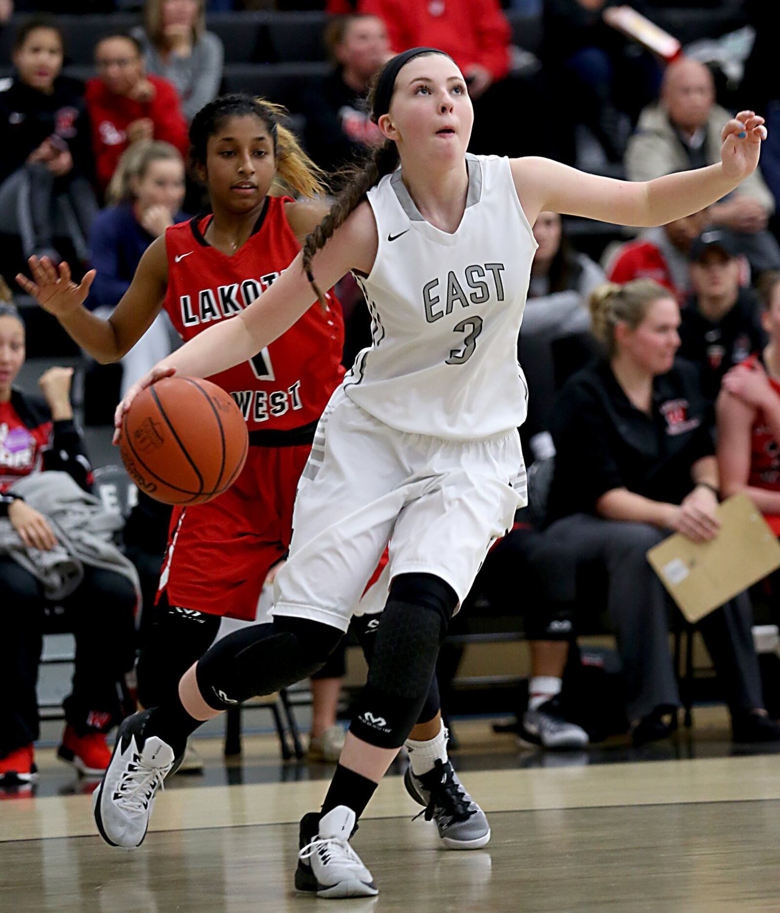 Lakota East guard Holly Thompson moves to the basket in front of Lakota West guard Bryana Henderson during their game at East on Wednesday night. CONTRIBUTED PHOTO BY E.L. HUBBARD