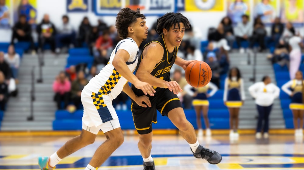 Centerville junior Trey Sam drives past Springfield senior Charles Cunningham during their Greater Western Ohio Conference game on Tuesday, Feb. 3, 2026. The Elks won 56-44. MICHAEL COOPER / STAFF