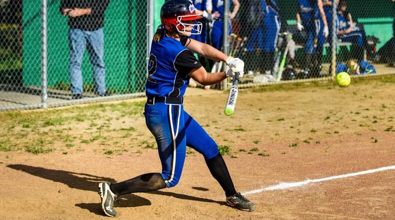 Cincinnati Christian’s Kristen McLaughlin makes contact with the ball during a Miami Valley Conference game at New Miami on April 24. NICK GRAHAM/STAFF