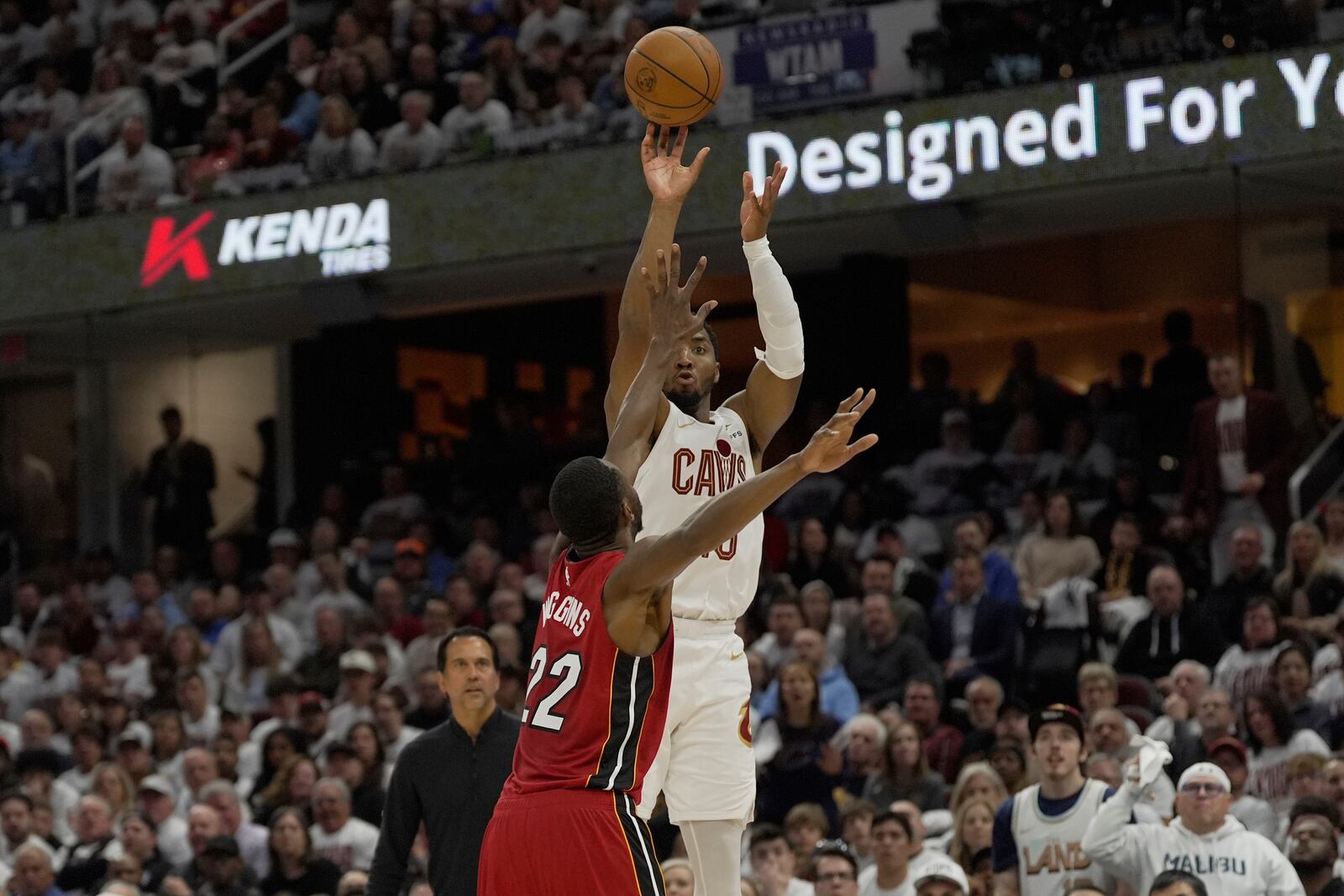 Cleveland Cavaliers guard Donovan Mitchell (45) shoots over Miami Heat forward Andrew Wiggins (22) in the second half in Game 1 of an NBA first-round playoff series, Sunday, April 20, 2025, in Cleveland. (AP Photo/Sue Ogrocki)