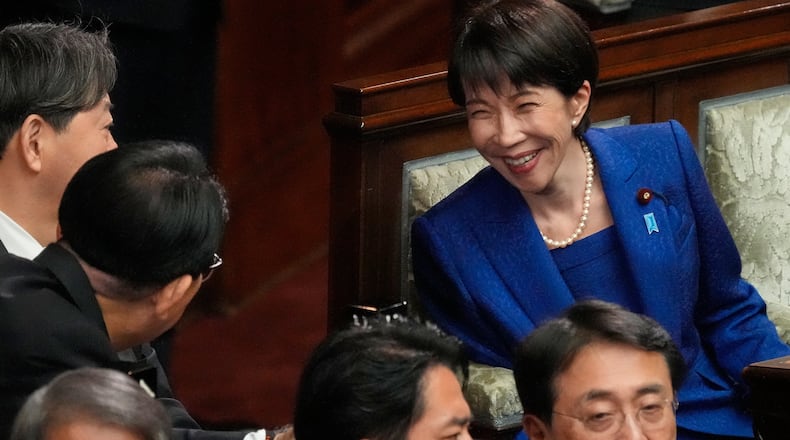 Japanese Prime Minister Sanae Takaichi, right, and other lawmakers speak before dissolving the lower house, during an extraordinary Diet session at the lower house of parliament Friday, Jan. 23, 2026, in Tokyo. (AP Photo/Eugene Hoshiko)