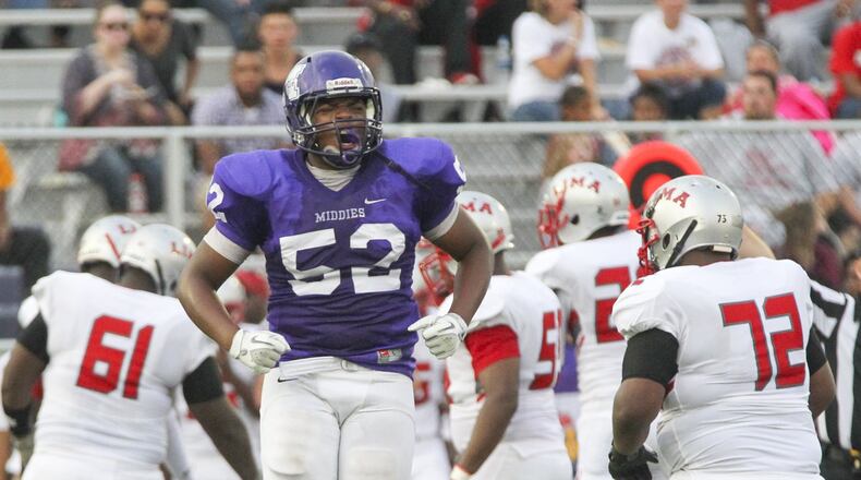 Middletown defensive lineman Keion Williams (52) celebrates a fumble recovery by the Middies during their game against Lima Senior at Barnitz Stadium in Middletown on Aug. 29, 2015. The visiting Spartans won 53-36. GREG LYNCH/STAFF