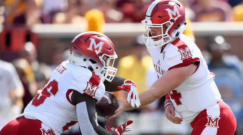 Miami quarterback Gus Ragland hands the ball to teammate Alonzo Smith vs. Minnesota on Sept. 15, 2018 at TCF Bank Stadium in Minneapolis, Minnesota. Smith rushed for 207 yards and scored three touchdowns in the RedHawks’ win over Ball State on Tuesday night. (Photo by Hannah Foslien/Getty Images)