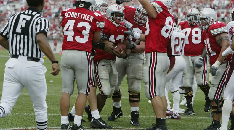 COLUMBUS, OH - SEPTEMBER 14: Maurice Clarett #13 of Ohio State is congratulated by his teammates after his touchdown during the game against Washington State on September 14, 2002 at Ohio Stadium in Ohio. Ohio State won the game, 25-7. (Photo by Tom Pidgeon/Getty Images)