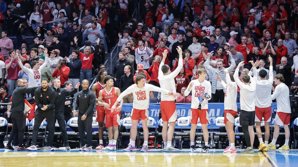 Miami players on the bench celebrate in the final seconds of an 89-79 win over Southern Methodist in an NCAA First Four game on Wednesday, March 18 at University of Dayton Arena. BRYANT BILLING / STAFF