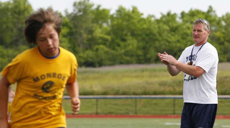 Monroe coach Brett Stubbs runs his football team through conditioning drills June 8, 2010, at Monroe. NICK GRAHAM/STAFF