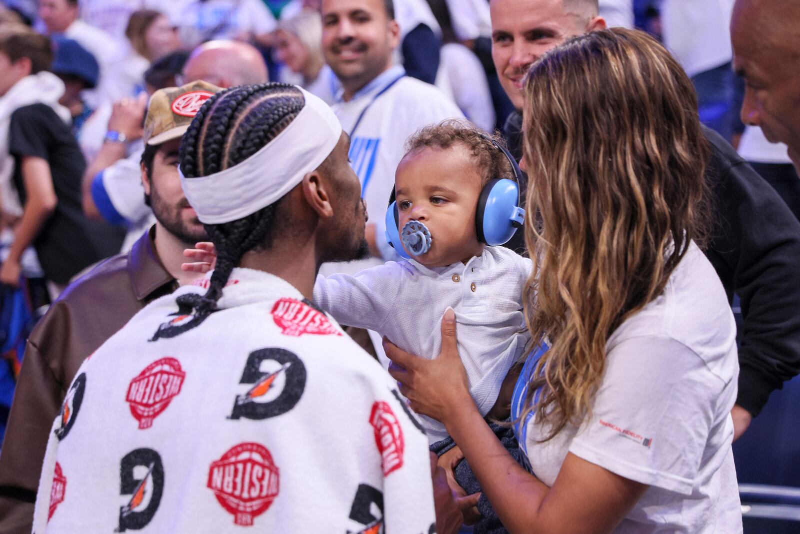Oklahoma City Thunder guard Shai Gilgeous-Alexander, left, meets with his wife, Hailey Summers, and their son Ares Alexander following Game 1 of an NBA basketball Western Conference Finals playoff series against the Minnesota Timberwolves Tuesday, May 20, 2025, in Oklahoma City. (AP Photo/Nate Billings)