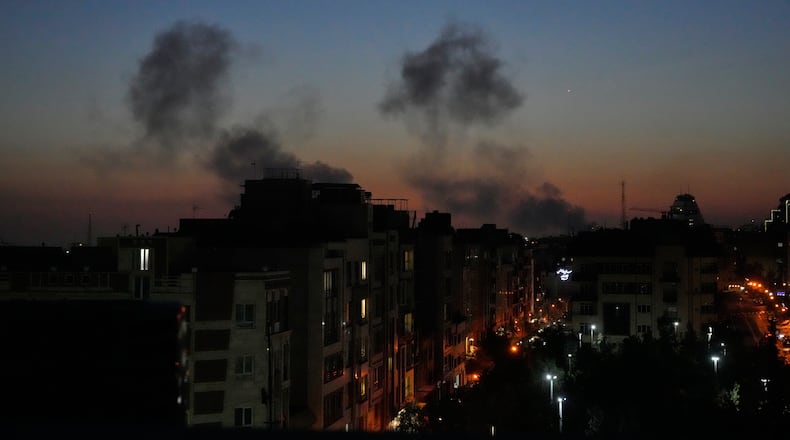 Plumes of smoke rise as strikes hit the city during the U.S.–Israeli military campaign in Tehran, Iran, Friday night, March 6, 2026. (AP Photo/Vahid Salemi)